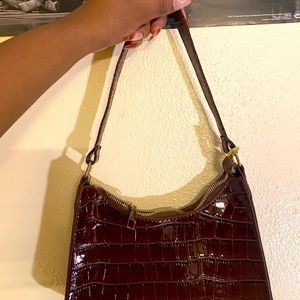 I am selling this brown bag because I am traveling back to Europe.